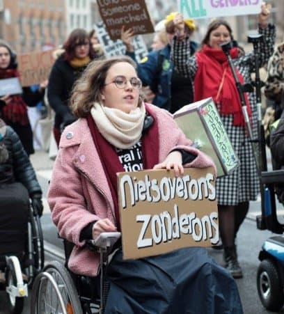 Woman in a wheelchair at a demonstration.